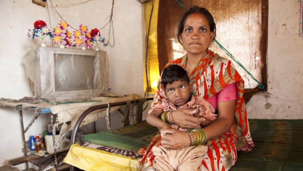 Poona Bai with her son, Raj, who is visually impaired and cannot walk.