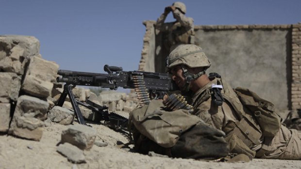 US Marines fire on Taliban positions from a rooftop in the village of Dahaneh.