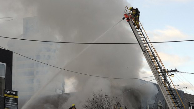 Brutal dealings ... Fire crews put out the Top on Tope brothel fire.