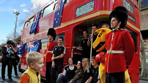 Boxing Kangaroo v Beefeater ... Australian Olympians alongside a London bus in Sydney at the one-year-to-go celebrations for London 2012.