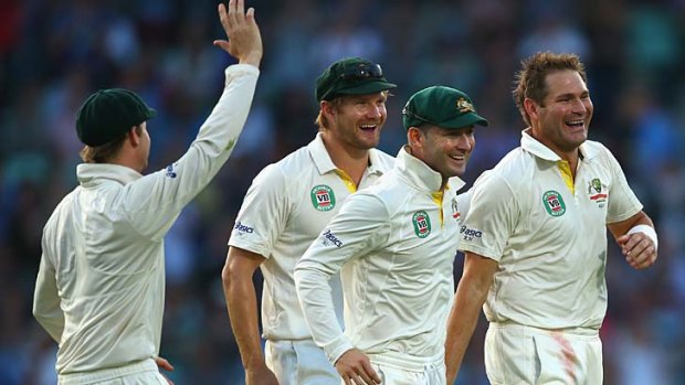 Ryan Harris of Australia celebrates with Michael Clarke and Shane Watson of Australia after taking the wicket of Kevin Pietersen.