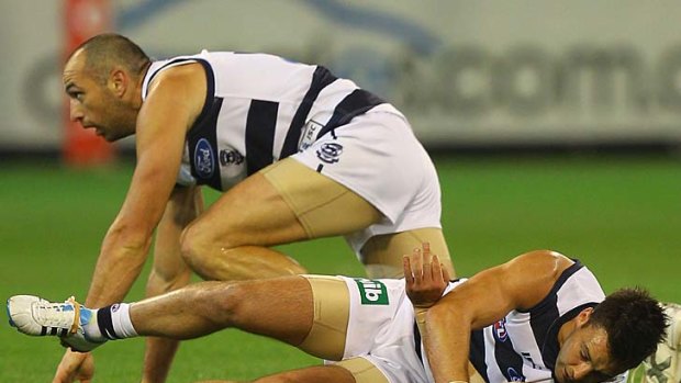 Jimmy Bartel goes to ground after taking a heavy hit to the head during the game against the Saints.