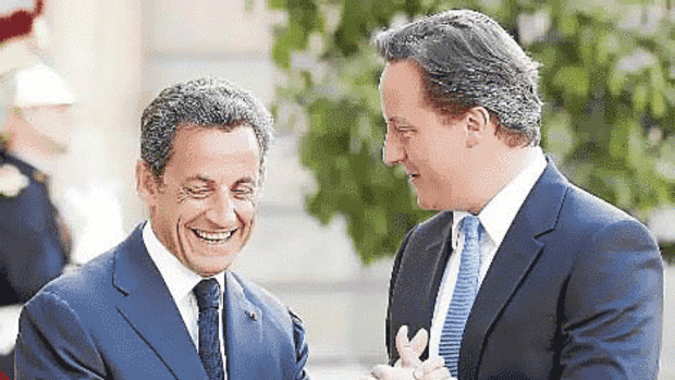 French President Nicolas Sarkozy greets Britain's Prime Minister David Cameron at the Elyse Palace in Paris.