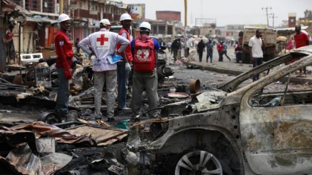 Earlier Boko Haram attack ... Red Cross personnel search for remains at the site of twin bomb explosions in Jos, Nigeria, which killed 100 on May 21.