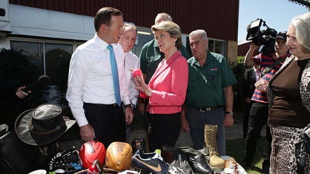 Straight man: Tony Abbott avoids horsing around with Julie Bishop at a Narangba leather goods shop in the seat of Petrie.