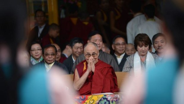 Tibetan spiritual leader His Holiness the Dalai Lama gestures during a commemoration event marking 25 years since he was awarded the Nobel peace prize.