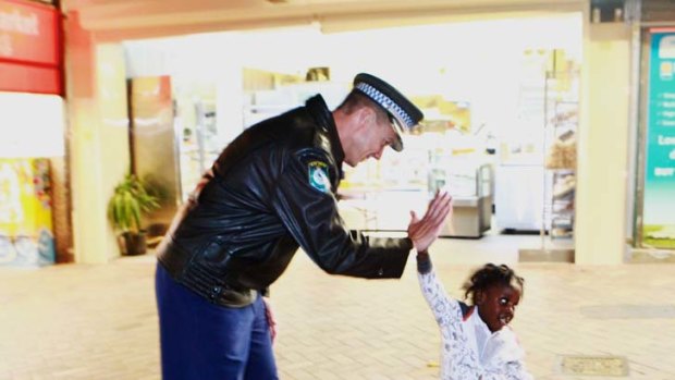 ’’Hi, gimme five’’... Superintendent Mark Wright with a young resident.