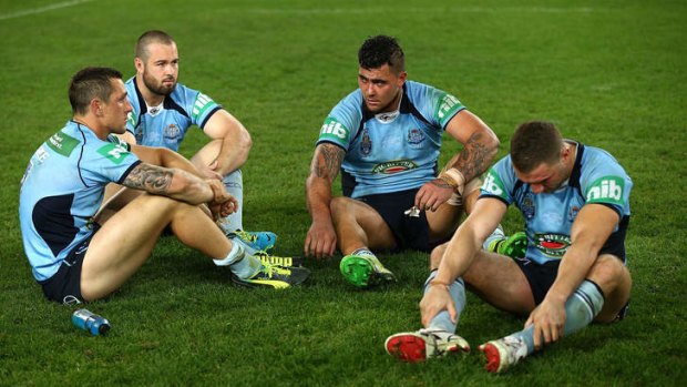 Dejected: Mitchell Pearce, Aaron Woods, Andrew Fifita and  Robbie Farah of the Blues let Wednesday night's loss sink in.
