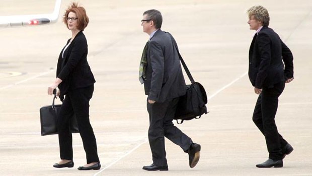 Taking flight: Prime Minister Julia Gillard and aides on the way to her VIP jet leaving Canberra at the end of a big week.