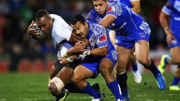 Strong contingent: Eto Nabuli of Fiji is tackled by the Samoan defence during Saturday night's Test.