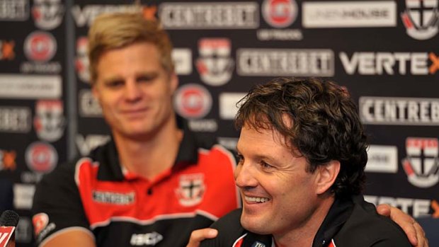 New St Kilda coach Scott Watters receiving a 'welcome hug' from his captain Nick Riewoldt.