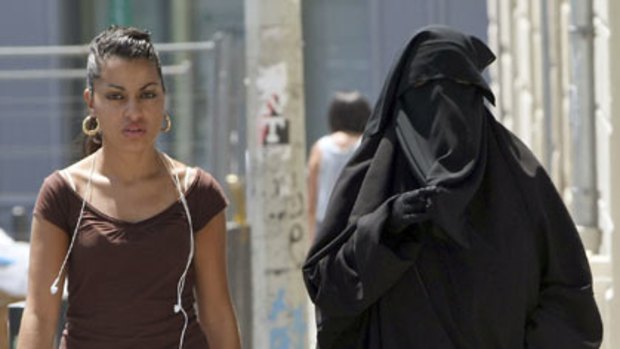 Street fashion ... two women, one wearing a burqa, walk side by side in the Belsunce district of Marseille.