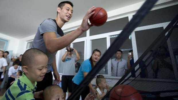 Ambassador: NBA star Jeremy Lin of the Houston Rockets throws a basketball with children while he visits an orphanage and rehabilitation centre that serves children with congenital illnesses such as cerebral palsy in Tianjin, China.