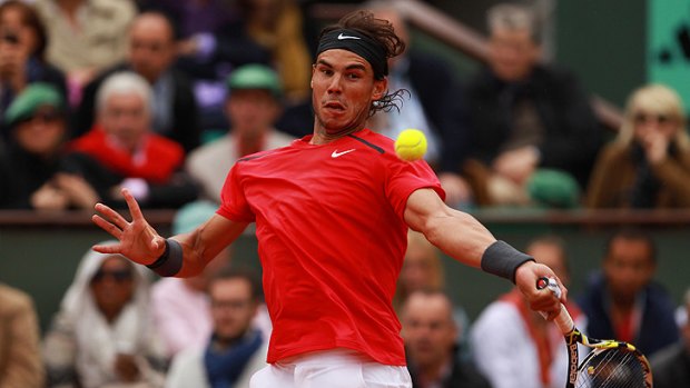 Rafael Nadal plays a forehand in the final at Roland Garros. The Spaniard clashed with officials over the wet conditions interfering with play.