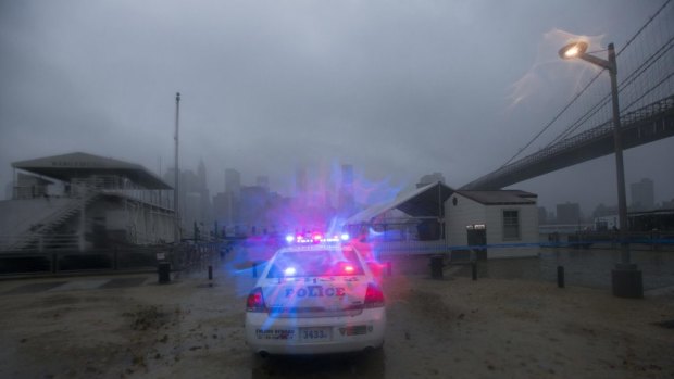 A police car patrols Brooklyn streets as hurricane Sandy hits in 2012.