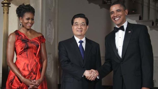 Barack and Michelle Obama greet Chinese President Hu Jintao in the White House in Washington.