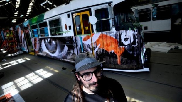 Street artist Rone with his designs on a tram for Melbourne Festival.