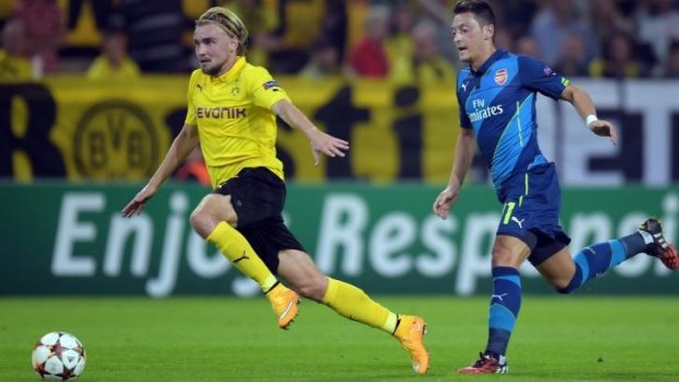 Ozil, right, trailing Marcel Schmelzer, has not impressed in the Premier League.  