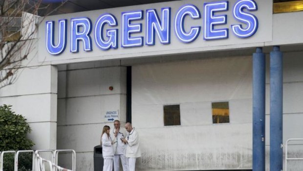 Members of the staff are seen outside the emergency services at the CHU Nord hospital in Grenoble, French Alps where Schumacher was first treated after the skiing accident.