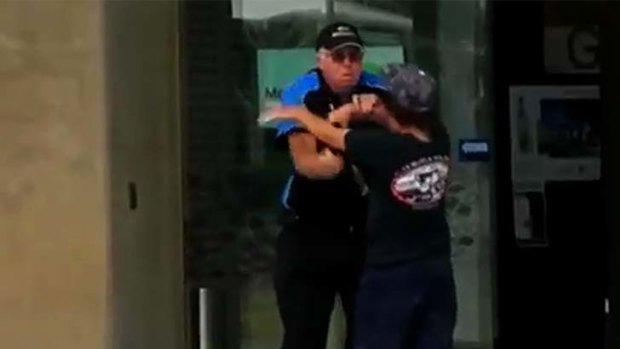 A teenager tussles with a security guard outside the Caboolture Hub library and art gallery.