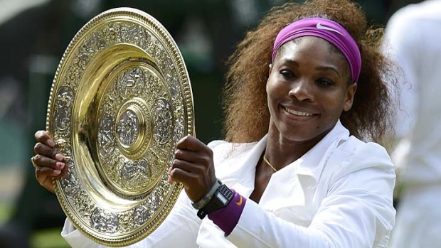 Serena Williams holds up her trophy after defeating Agnieszka Radwanska.