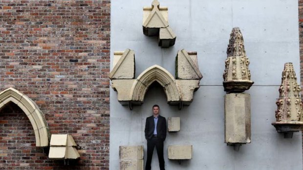 ''Our gift to the city'' ... the Reverend Mike Paget with relics of the previous St Barnabas Anglican Church, which burnt down in 2006.