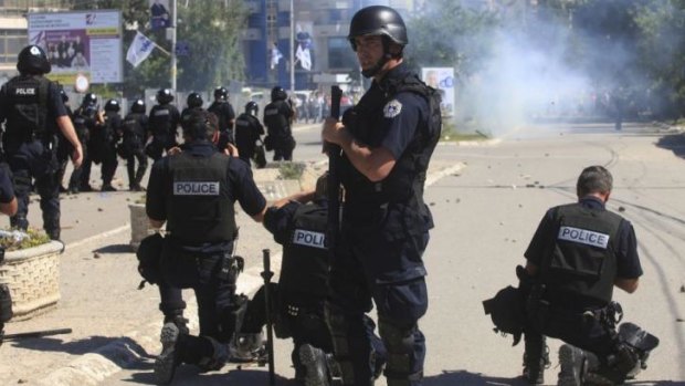 Police release tear gas at Kosovo Albanian demonstrators in Mitrovica on Sunday.