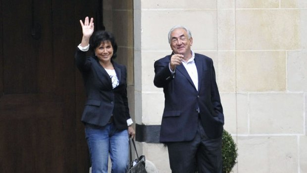 Dominique Strauss-Kahn and his wife, Anne Sinclair, outside their apartment in the luxurious Place des Vosges square in central Paris.