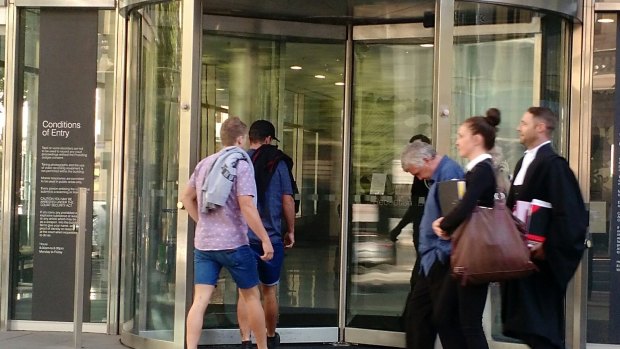 Anthony McNamara, on right in blue shirt, leaves court on Thursday