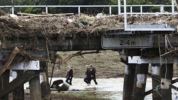 Police divers search for flood victims by the bridge in Grantham.