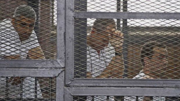 Facing terror charges: from left, Mohammed Fahmy, Peter Greste and Baher Mohamed in a defendant's cage during their trial on May 15.
