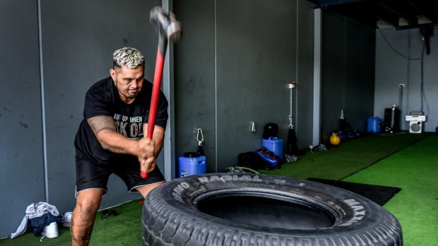 Hunt takes it out on a truck tyre in his gym.