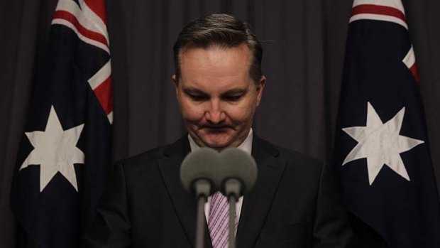 Chris Bowen resigns as a minister during a press conference at Parliament House.