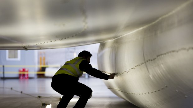 A worker inspects the skin of the hull of the Airlander 10.