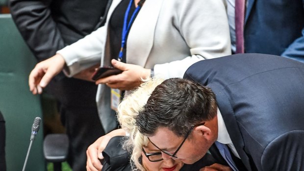 Premier Daniel Andrews embraces health minister Jill Hennessy after the vote after a marathon debating session.