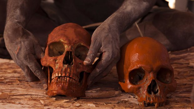 Skulls are covered in red ochre and wrapped in paberback, as human remains are finally reurned to their ancestral home in Gunbalanya. Photo by Walkley nominated photographer Glenn Campbell.