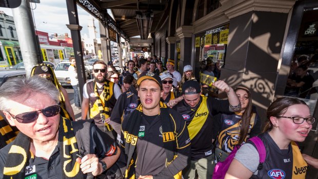 The Tiger Army march from the Spread Eagle Hotel in Richmond, to the MCG ahead of the big final last week. 