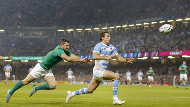 Flyer: Argentina's Juan Imhoff, right, races clear of Ireland's Rob Kearney before catching the ball to score.