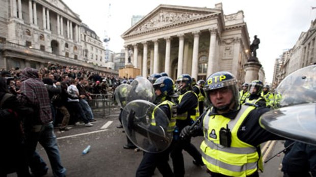 Police clash with protesters during a clash outside the Bank of England in London yesterday.