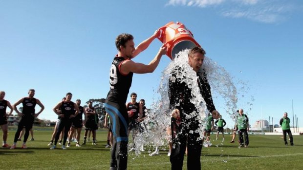 Essendon coach Mark Thompson joins the Ice Bucket Challenge at training.