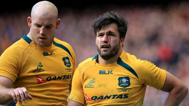 Walking wounded: Adam Ashley-Cooper, flanked by Wallabies teammate Stephen Moore, bears the scars of battle.