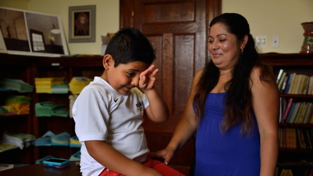 Reyna, 30, and her son Daniel, 7, are undocumented migrants from El Salvador, living in Hyattsville, Maryland. Daniel made the dangerous illegal crossing through Mexico to be with his parents.