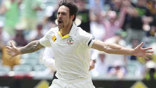 Mitchell Johnson celebrates after taking the wicket of Stuart Broad.