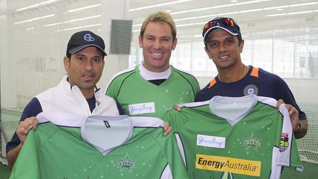 Indian cricketers Sachin Tendulkar and Rahul Dravid hold up Melbourne Stars gear as they pose with Shane Warne at the MCG on Tuesday.