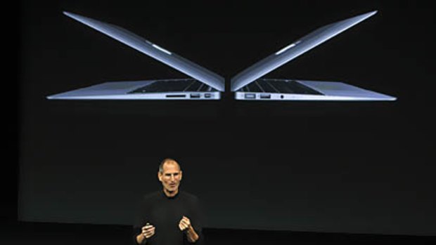 Apple CEO Steve Jobs unveils the company's latest high-end ultra-thin MacBook Air laptop models during a news conference at Apple headquarters in Cupertino, California.