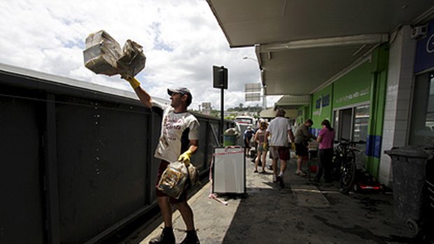 Businesses start the clean up in Ipswich's CBD on January 14.