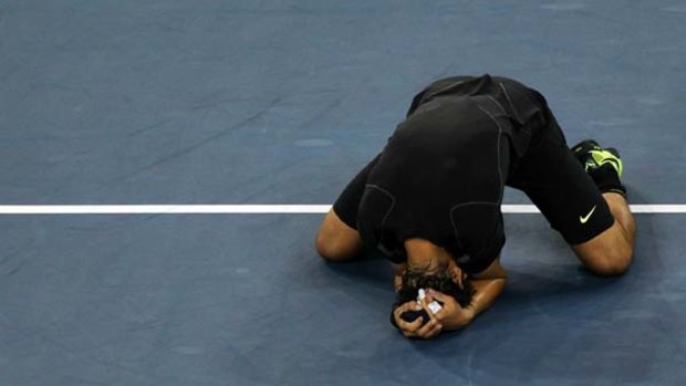 Rafael Nadal of Spain falls to his knees in celebration of his win over Novak Djokovic.