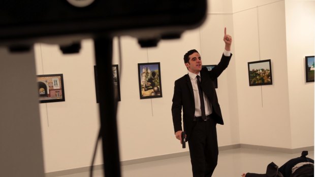 A man with a gun shouts inside the Ankara gallery as Russian ambassador to Turkey Andrei Karlov lies on the ground.