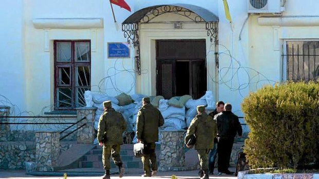 Endgame: Russian officers enter the Ukrainian marine battalion headquarters to discuss its surrender in the Crimean city of Feodosia.