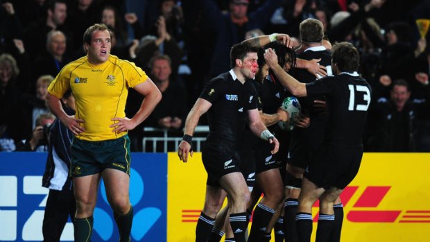 Wallaby Ben Alexander shows his dejection as the All Blacks celebrate after Ma'a Nonu scores the only try at Eden Park last night.